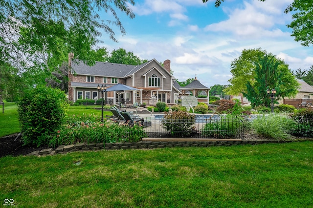115 Jordan Rd, Indianapolis, IN 46217 - rear view of house featuring a gazebo, a chimney, a lawn, and a patio area