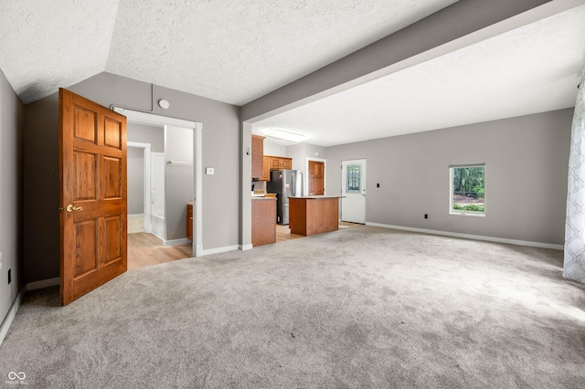 115 Jordan Rd, Indianapolis, IN 46217 - unfurnished living room featuring light carpet and a textured ceiling