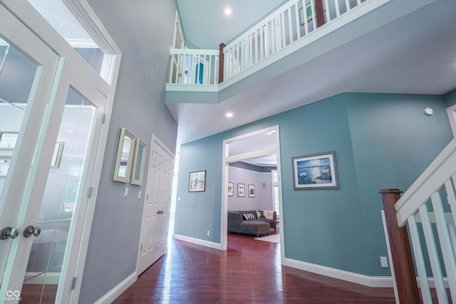 13299 W Wildflower Dr, Columbus, IN 47201 - foyer entrance featuring wood finished floors, stairs, and a high ceiling