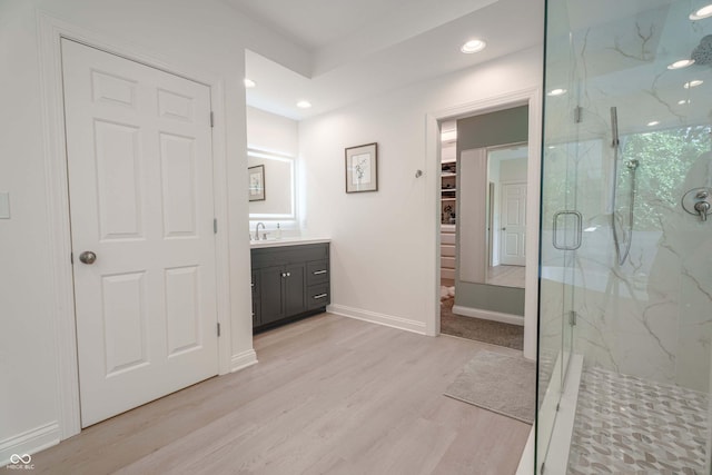 13299 W Wildflower Dr, Columbus, IN 47201 - bathroom with a marble finish shower, vanity, wood finished floors, a spacious closet, and recessed lighting