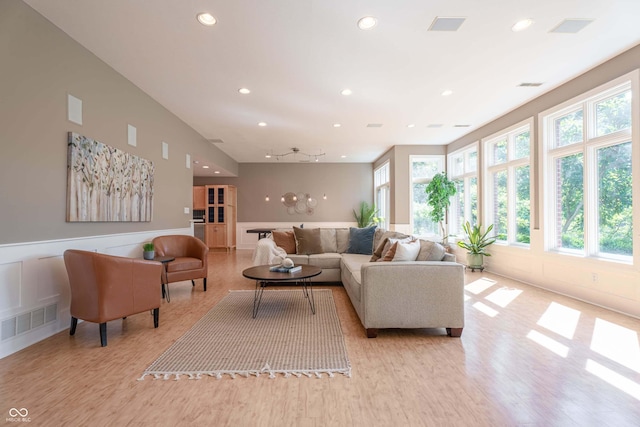 13299 W Wildflower Dr, Columbus, IN 47201 - living room featuring plenty of natural light, light wood-type flooring, recessed lighting, and a wainscoted wall