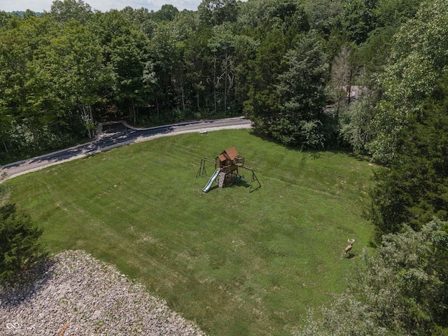 13299 W Wildflower Dr, Columbus, IN 47201 - view of grassy yard with a playground and a view of trees