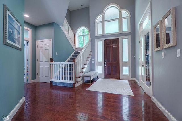 13299 W Wildflower Dr, Columbus, IN 47201 - entrance foyer featuring wood-type flooring, stairs, and a high ceiling