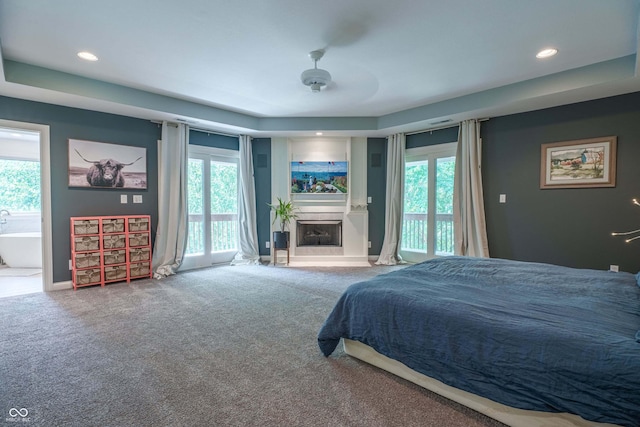 13299 W Wildflower Dr, Columbus, IN 47201 - carpeted bedroom with access to exterior, multiple windows, a fireplace, recessed lighting, and ensuite bathroom