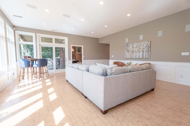 13299 W Wildflower Dr, Columbus, IN 47201 - living room with a decorative wall, a wainscoted wall, recessed lighting, and light wood-style floors