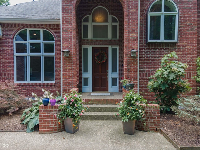 13299 W Wildflower Dr, Columbus, IN 47201 - property entrance featuring roof with shingles and brick siding