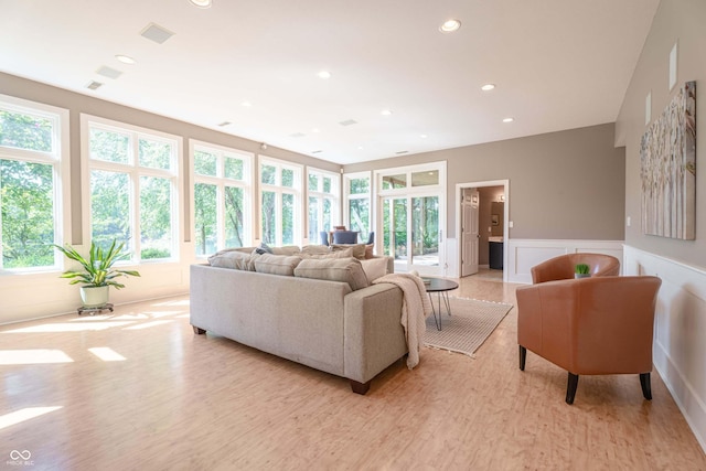 13299 W Wildflower Dr, Columbus, IN 47201 - living room featuring light wood-type flooring, wainscoting, a decorative wall, and recessed lighting