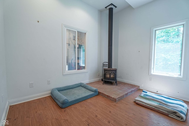 13299 W Wildflower Dr, Columbus, IN 47201 - unfurnished bedroom featuring a wood stove and wood finished floors