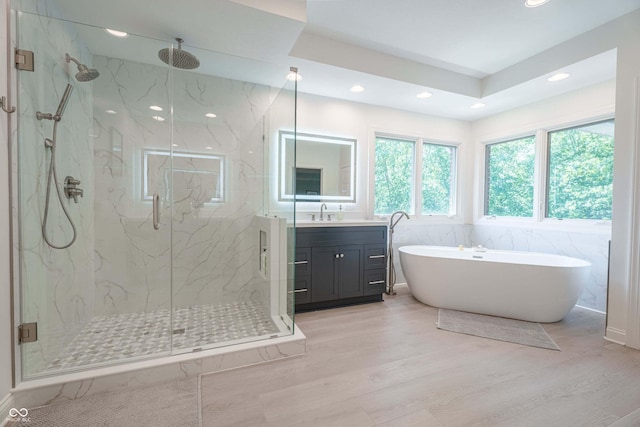 13299 W Wildflower Dr, Columbus, IN 47201 - full bathroom featuring a marble finish shower, vanity, wood finished floors, a freestanding bath, and recessed lighting