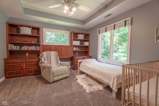13299 W Wildflower Dr, Columbus, IN 47201 - bedroom featuring carpet flooring, ceiling fan, and a tray ceiling
