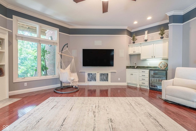 13299 W Wildflower Dr, Columbus, IN 47201 - living area featuring wine cooler, wet bar, plenty of natural light, ceiling fan, and ornamental molding