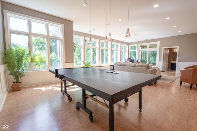 13299 W Wildflower Dr, Columbus, IN 47201 - rec room with light wood-style flooring, wainscoting, recessed lighting, and a decorative wall