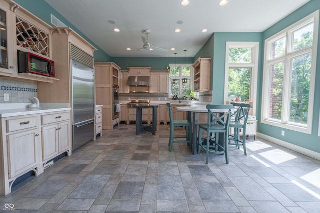 13299 W Wildflower Dr, Columbus, IN 47201 - kitchen featuring open shelves, appliances with stainless steel finishes, under cabinet range hood, decorative backsplash, and plenty of natural light