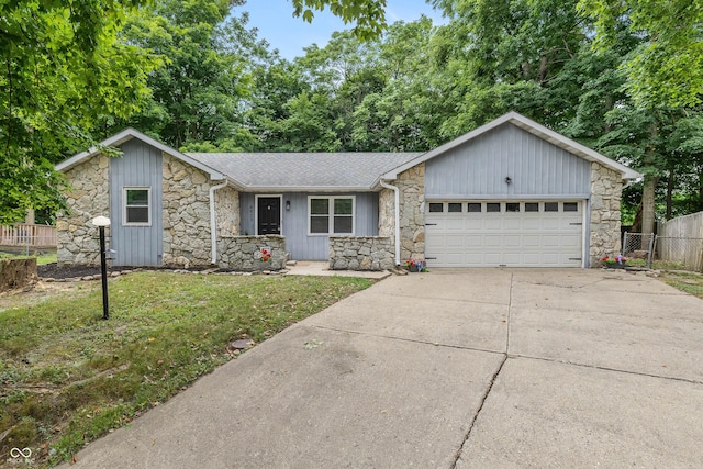 4823 Tempe Ct, Indianapolis, IN 46241 - ranch-style home with stone siding, driveway, a garage, and roof with shingles