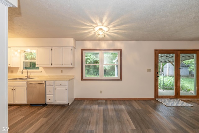 4823 Tempe Ct, Indianapolis, IN 46241 - kitchen with stainless steel dishwasher, light countertops, dark wood-style floors, white cabinetry, and a textured ceiling