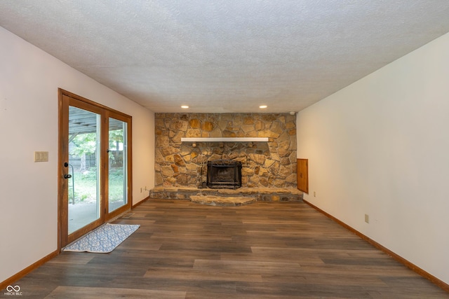 4823 Tempe Ct, Indianapolis, IN 46241 - unfurnished living room with wood finished floors, a textured ceiling, a stone fireplace, and recessed lighting