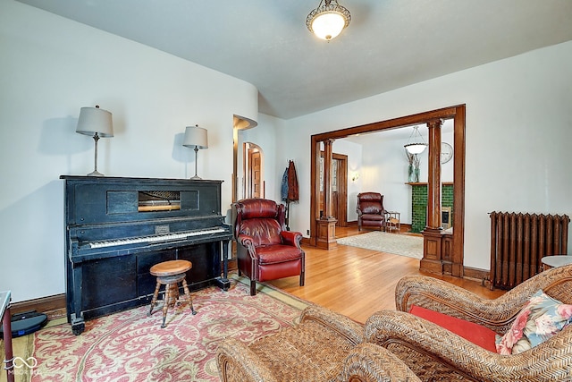 1934 N New Jersey St, Indianapolis, IN 46202 - sitting room with radiator heating unit, wood finished floors, and arched walkways