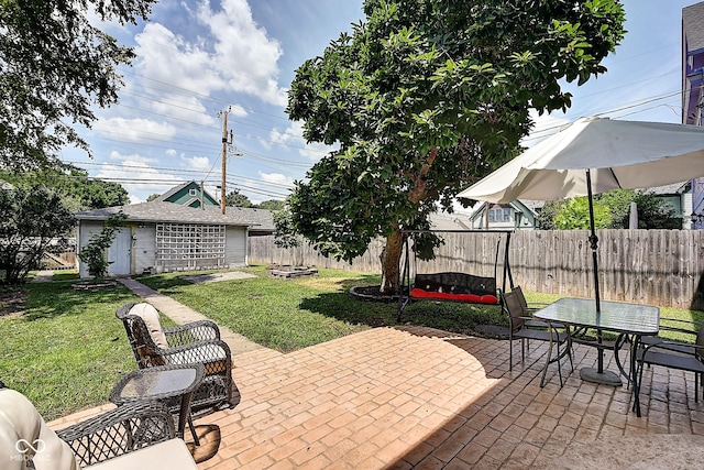 1934 N New Jersey St, Indianapolis, IN 46202 - fenced backyard with a patio, an outbuilding, and outdoor dining space