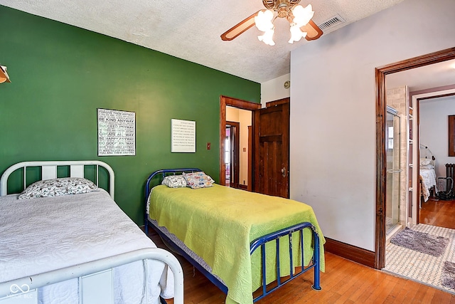 1934 N New Jersey St, Indianapolis, IN 46202 - bedroom featuring hardwood / wood-style floors, a textured ceiling, and a ceiling fan