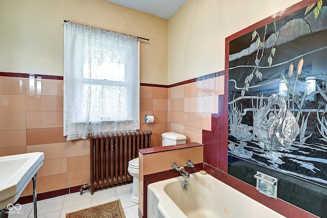 1934 N New Jersey St, Indianapolis, IN 46202 - bathroom with tile walls, radiator heating unit, a bath, tile patterned floors, and a wainscoted wall