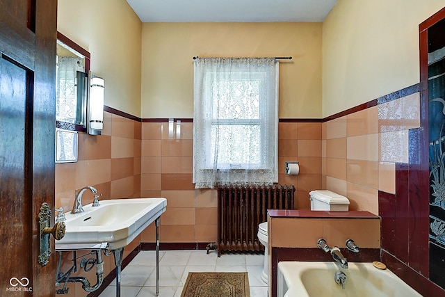 1934 N New Jersey St, Indianapolis, IN 46202 - full bath featuring radiator, tile walls, a bath, tile patterned flooring, and wainscoting