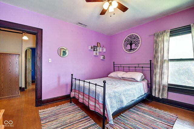 1934 N New Jersey St, Indianapolis, IN 46202 - bedroom featuring wood finished floors, arched walkways, and a ceiling fan