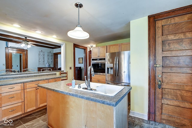 1934 N New Jersey St, Indianapolis, IN 46202 - kitchen with stainless steel appliances, a kitchen island with sink, light brown cabinetry, hanging light fixtures, and ceiling fan