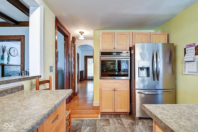 1934 N New Jersey St, Indianapolis, IN 46202 - kitchen with appliances with stainless steel finishes, light brown cabinetry, and arched walkways