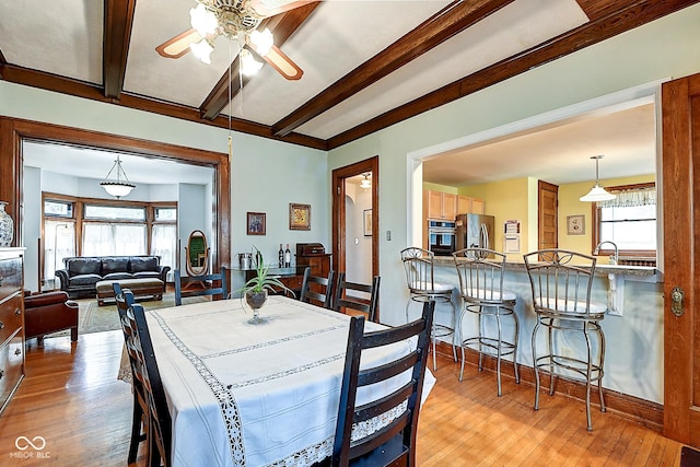 1934 N New Jersey St, Indianapolis, IN 46202 - dining area featuring ceiling fan, light wood finished floors, and beamed ceiling