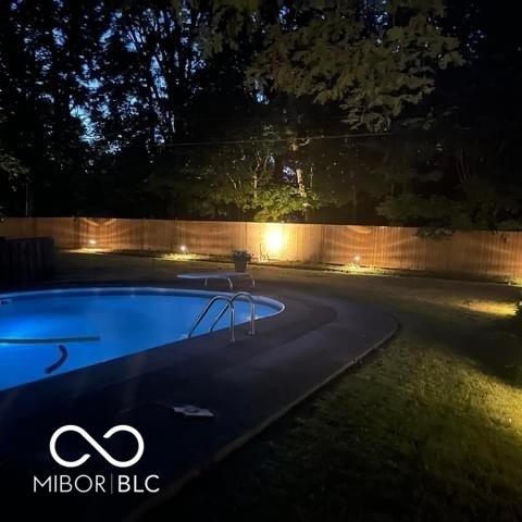 10308 Stormhaven Way, Indianapolis, IN 46256 - pool at night with a fenced backyard