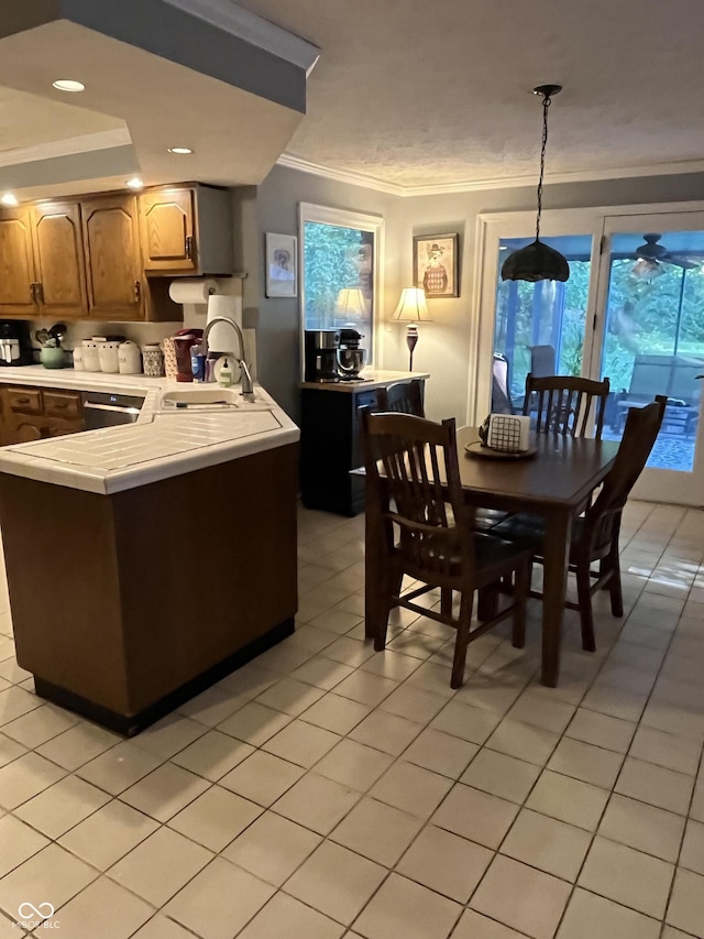 10308 Stormhaven Way, Indianapolis, IN 46256 - kitchen with ornamental molding, light tile patterned flooring, a peninsula, pendant lighting, and dishwashing machine