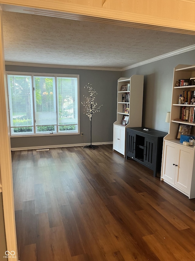 10308 Stormhaven Way, Indianapolis, IN 46256 - unfurnished living room with a textured ceiling, dark wood finished floors, and crown molding