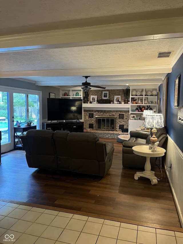 10308 Stormhaven Way, Indianapolis, IN 46256 - living room with wood finished floors, a ceiling fan, a fireplace, wainscoting, and beamed ceiling
