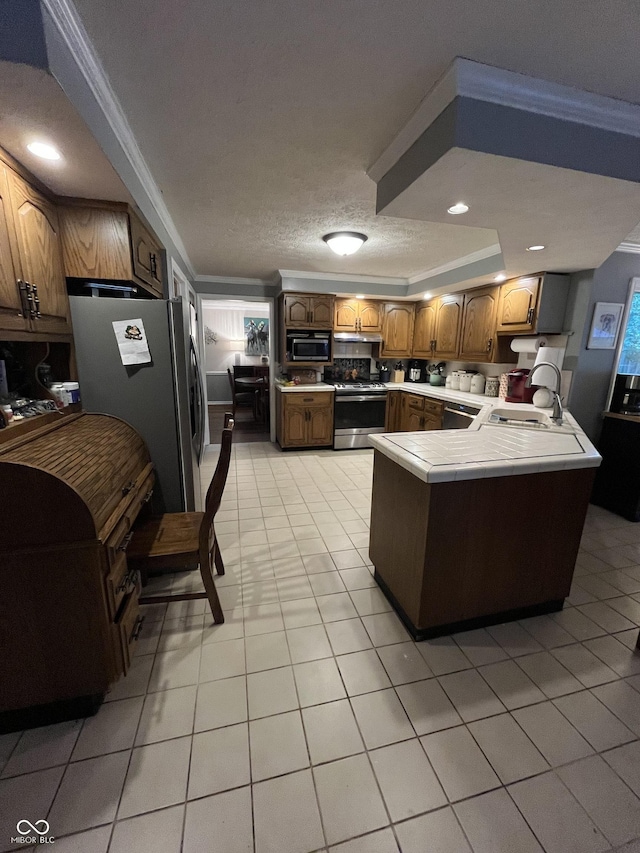 10308 Stormhaven Way, Indianapolis, IN 46256 - kitchen featuring appliances with stainless steel finishes, a peninsula, light tile patterned floors, tile countertops, and crown molding