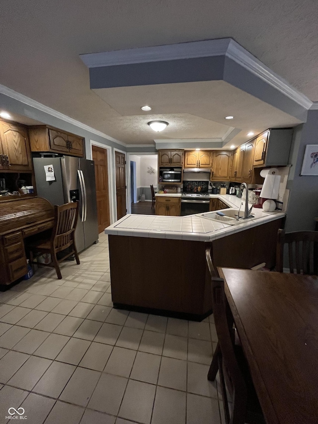 10308 Stormhaven Way, Indianapolis, IN 46256 - kitchen featuring stainless steel appliances, ornamental molding, tile counters, a peninsula, and light tile patterned flooring