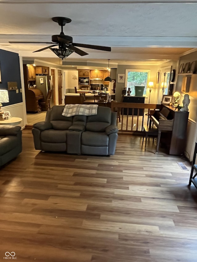 10308 Stormhaven Way, Indianapolis, IN 46256 - living area featuring wood finished floors, a ceiling fan, and crown molding