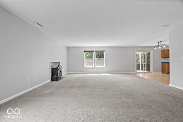 13386 Smokey Quartz Ln, Fishers, IN 46038 - unfurnished living room with light colored carpet, a fireplace with flush hearth, and healthy amount of natural light