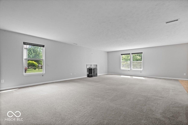 13386 Smokey Quartz Ln, Fishers, IN 46038 - unfurnished living room featuring a fireplace, a textured ceiling, and carpet floors