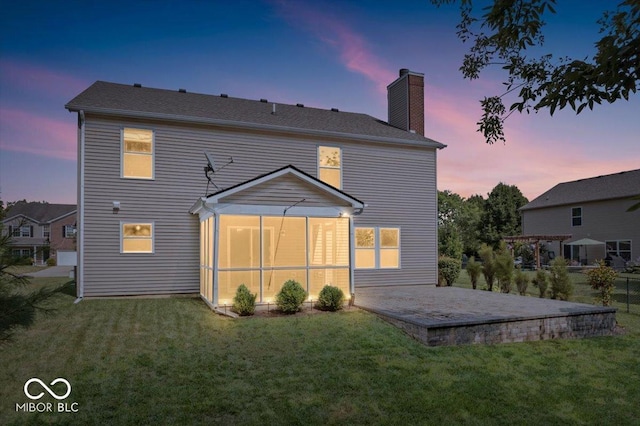 13386 Smokey Quartz Ln, Fishers, IN 46038 - back of property featuring a lawn, a chimney, and a patio area
