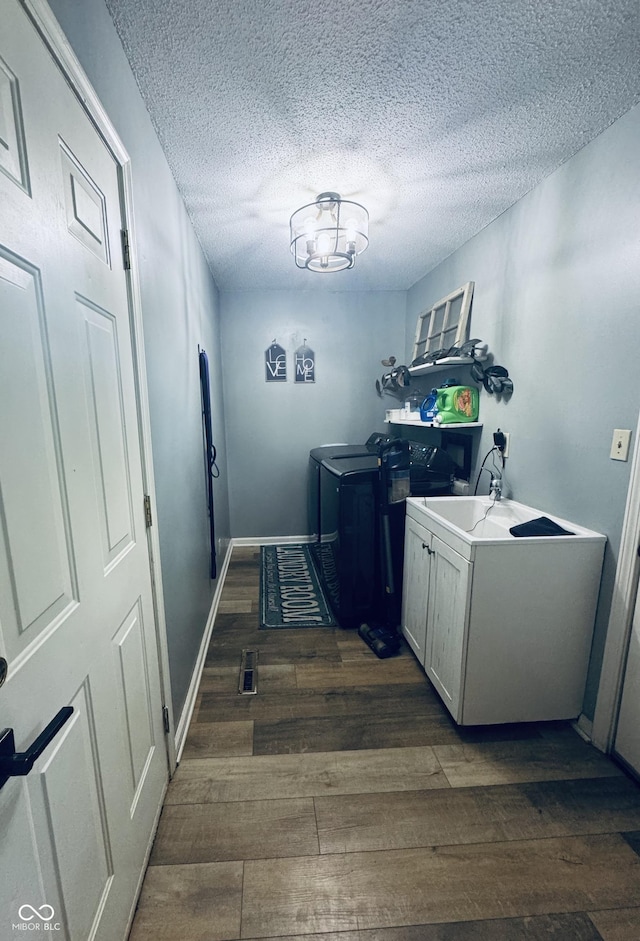 5818 N Fortville Pike, Greenfield, IN 46140 - washroom featuring washer and clothes dryer, dark wood finished floors, a textured ceiling, and cabinet space