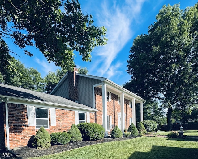 5818 N Fortville Pike, Greenfield, IN 46140 - view of side of home featuring a yard, brick siding, and a chimney