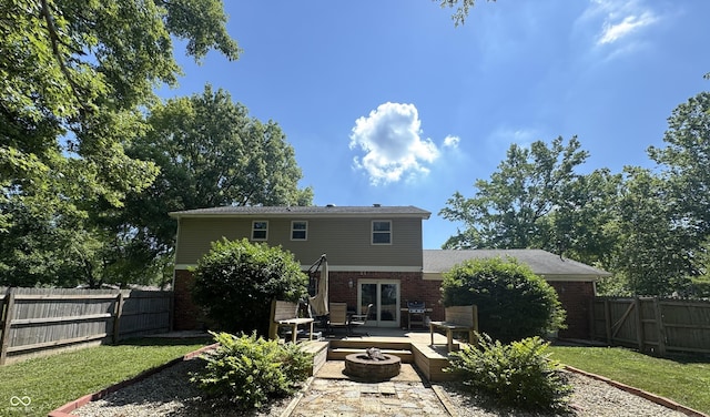 5818 N Fortville Pike, Greenfield, IN 46140 - back of property with a fire pit, brick siding, a fenced backyard, and a patio area