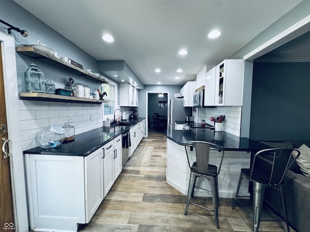 5818 N Fortville Pike, Greenfield, IN 46140 - kitchen with open shelves, stainless steel appliances, light wood-type flooring, tasteful backsplash, and recessed lighting