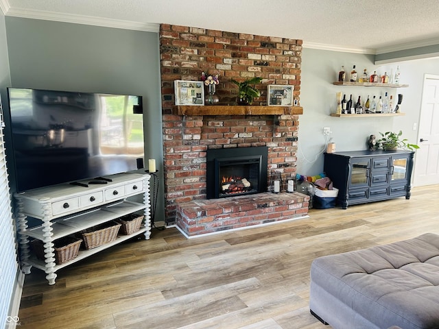 5818 N Fortville Pike, Greenfield, IN 46140 - living room with ornamental molding, wood finished floors, a textured ceiling, a fireplace, and a bar