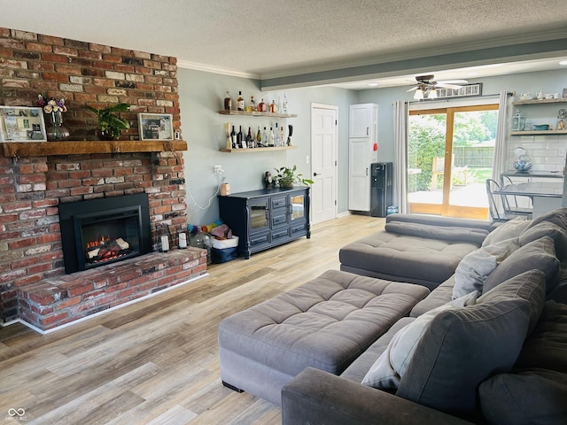 5818 N Fortville Pike, Greenfield, IN 46140 - living room with a textured ceiling, ornamental molding, bar area, a ceiling fan, and light wood-style floors