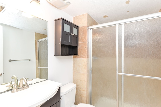 7547 Prairie Lake Dr, Indianapolis, IN 46256 - full bathroom featuring vanity, a shower with door, and a textured ceiling