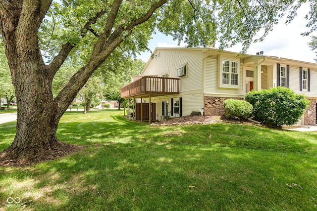 7547 Prairie Lake Dr, Indianapolis, IN 46256 - view of home's exterior featuring brick siding, a lawn, and a deck