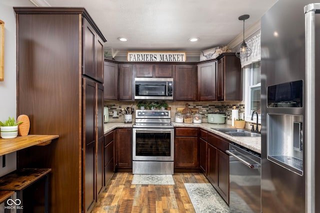 2748 S Meridian Rd, Greenfield, IN 46140 - kitchen with appliances with stainless steel finishes, light wood-type flooring, dark brown cabinets, and decorative backsplash