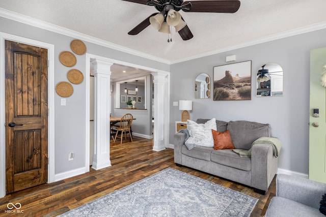 2748 S Meridian Rd, Greenfield, IN 46140 - living area with decorative columns, wood finished floors, a ceiling fan, and ornamental molding