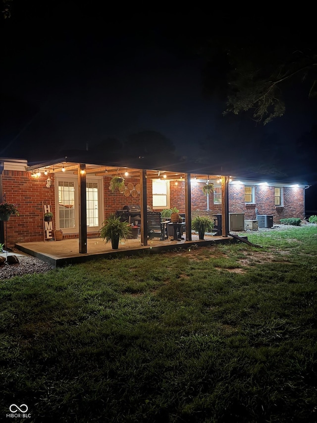 2748 S Meridian Rd, Greenfield, IN 46140 - back of house at twilight with brick siding and a yard